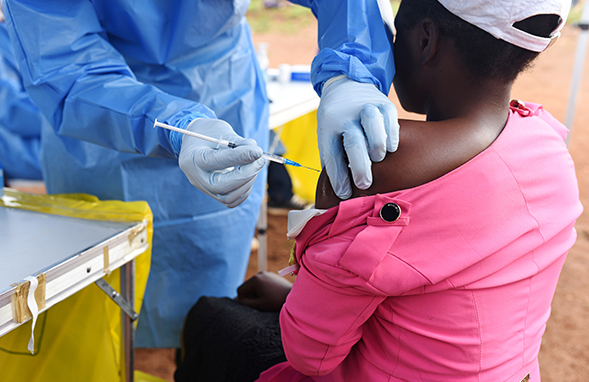 A Congolese health worker administers Ebola vaccine in DRC, August 2018