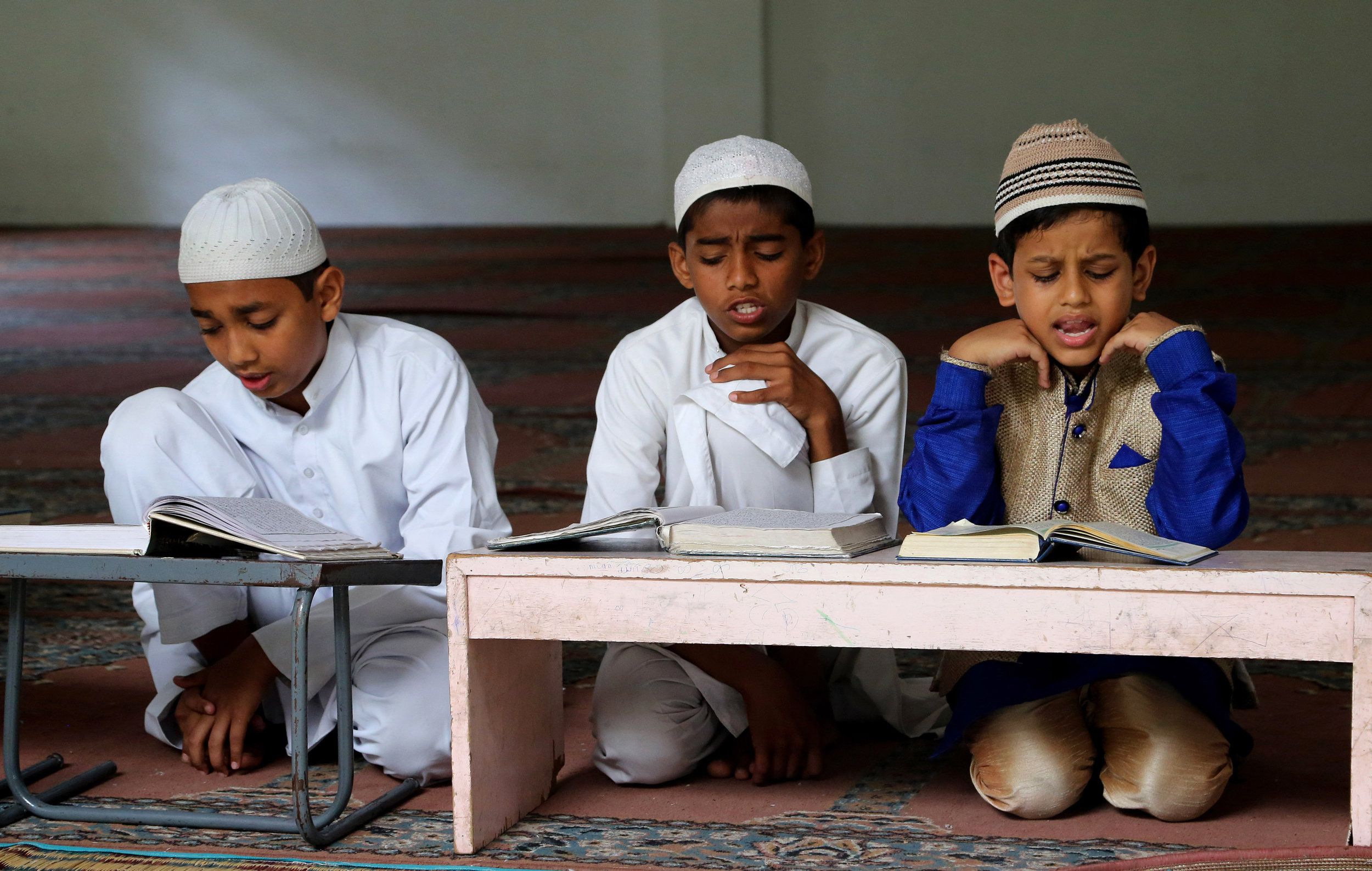 Indian Muslims study the Holy Quran in a madrasa